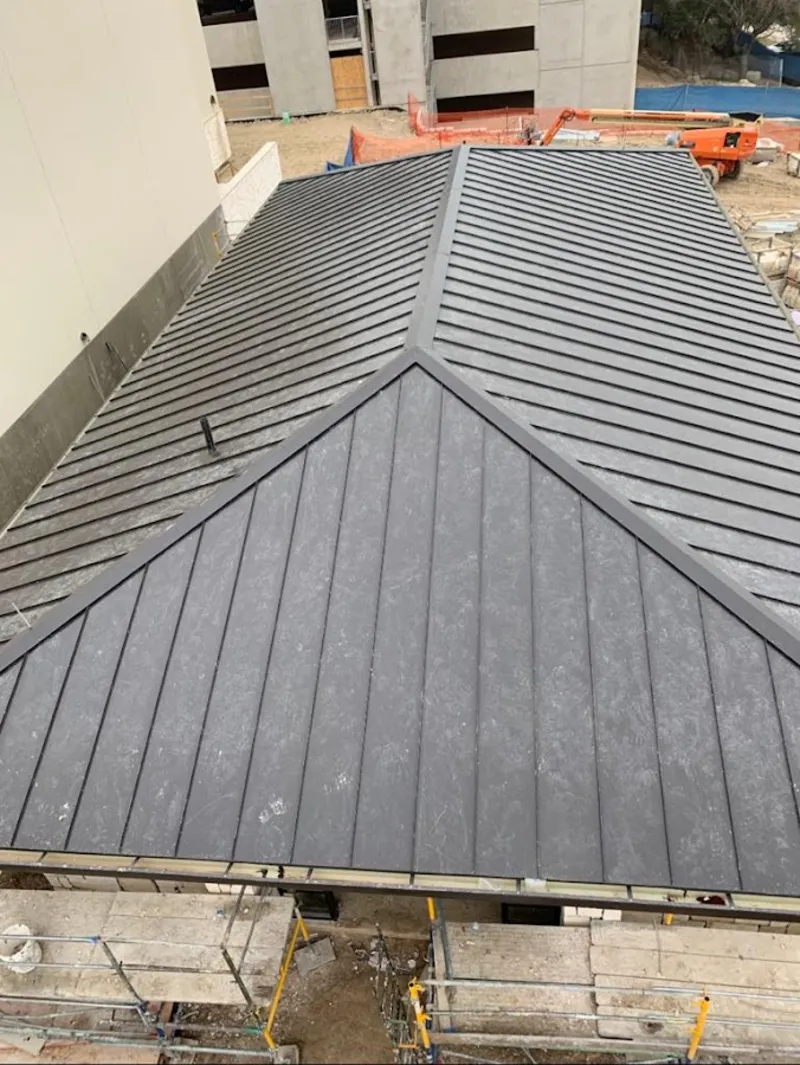 Commercial metal roof construction with crane equipment in Temple Hills