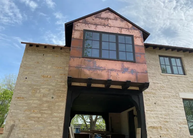 Copper metal panel facade on a stone building for Roof Repair in Temple Hills